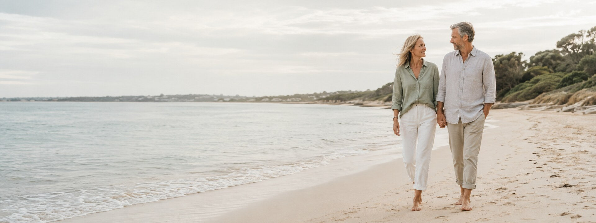 Adult couple walking together on an Australian beach